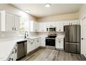 Modern kitchen equipped with stainless steel appliances and white cabinetry at 114 Seastone St, Raleigh, NC 27603
