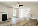 Cozy living room showcasing wood floors, a fireplace, and access to the kitchen at 114 Seastone St, Raleigh, NC 27603