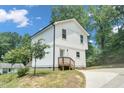 Side view of white home showing driveway, yard, and back entry at 1213 Grant St, Durham, NC 27701