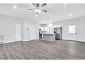 Open concept living room with new flooring and access to the modern kitchen at 1213 Grant St, Durham, NC 27701