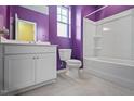 Bright bathroom featuring a white vanity, toilet, and a shower-tub combination at 136 Durie Way, Garner, NC 27529