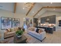 Open-concept living space flows from the living room to the kitchen and features hardwood floors and neutral decor at 16 Calming Pl Pl, Fuquay Varina, NC 27526