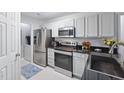Modern kitchen with stainless steel appliances, white cabinets, and black countertops at 1851 Trailwood Heights Ln # 201, Raleigh, NC 27603