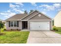 Well maintained home with manicured front lawn and an attached two car garage at 2040 Alderman Way, Creedmoor, NC 27522