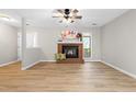 Spacious living room with hardwood floors, brick fireplace, and bright windows providing great natural light at 232 Clancy Cir, Cary, NC 27511