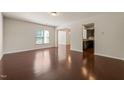 Bright living room featuring hardwood floors and an open layout to the kitchen at 236 Lynchwick Ln, Durham, NC 27703