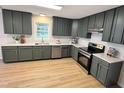 Modern kitchen with stainless steel appliances, sleek countertops, and updated cabinets and fixtures at 3212 Potthast Ct, Raleigh, NC 27529