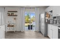 Modern kitchen featuring stainless steel refrigerator and sliding glass door to patio at 3641 Drafton Dr, Raleigh, NC 27610