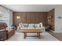 A comfortable living room with hardwood floors, a modern sofa, and stylish wall accents at 3641 Drafton Dr, Raleigh, NC 27610