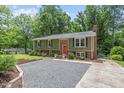Spacious driveway leading to a well-maintained home, surrounded by lush greenery and mature trees at 4404 Oak Park Rd, Raleigh, NC 27612
