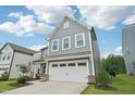 Two-story home with a two-car garage, gray siding, and a well-manicured lawn at 478 Curling Creek Dr, Clayton, NC 27527