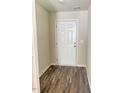 Bright entryway featuring wood-look flooring and a white front door, creating a welcoming first impression at 50 Teal Dr, Youngsville, NC 27596