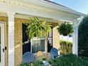 Cozy front porch featuring hanging ferns and a seating area, perfect for relaxing outdoors at 5849 Ricker Rd, Raleigh, NC 27610