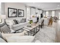 Open-concept living space blends a contemporary living room and kitchen, perfect for gatherings and entertaining at 705 Tambor Rd, Durham, NC 27713