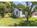 A lush green backyard with white brick house, and privacy fence at 709 Brighton Rd, Raleigh, NC 27610