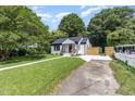A charming home with a white walkway, set amidst lush green trees at 709 Brighton Rd, Raleigh, NC 27610