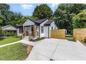 Inviting home with a new walkway and concrete driveway nestled among lush trees at 709 Brighton Rd, Raleigh, NC 27610