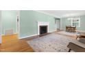 Bright living room featuring a decorative fireplace, hardwood floors, and neutral paint at 827 Union St, Cary, NC 27511