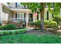 Charming front porch featuring decorative lanterns, lush landscaping, and a welcoming entrance to the home at 8712 Walkelin Ct, Raleigh, NC 27615