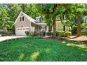 Beautifully landscaped front yard featuring a two-story home with a well-manicured lawn, a porch, and an attached garage at 8712 Walkelin Ct, Raleigh, NC 27615