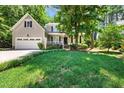 Charming two-story home featuring a well-manicured lawn, a front porch, and an attached two-car garage at 8712 Walkelin Ct, Raleigh, NC 27615