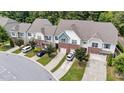 Aerial shot of townhomes surrounded by mature trees and well manicured landscaping at 927 Contessa Dr, Cary, NC 27513