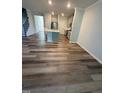 Open-concept living area with luxury vinyl plank flooring and neutral paint at 0416 Hazy Hls Ln, Garner, NC 27529