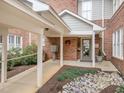 Inviting entrance with covered walkway, landscaping, and decorative details, enhancing the curb appeal of the building at 100 Edenburgh Rd # 202, Raleigh, NC 27608
