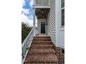 View of the stairs leading to the front door of a home with white siding at 108 Bally Shannon Way, Apex, NC 27539