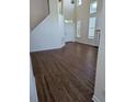 Bright living room featuring hardwood floors and abundant natural light from large windows at 108 Bally Shannon Way, Apex, NC 27539