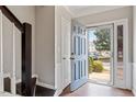 Inviting entryway showcasing the front door and staircase with natural light pouring in at 110 Great Ridge Ct, Morrisville, NC 27560