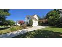 Charming home featuring a long driveway and meticulously landscaped front yard at 1106 Brittley Way, Apex, NC 27502