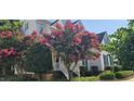 Beautiful home exterior featuring a flowering tree and well-maintained landscaping at 1106 Brittley Way, Apex, NC 27502