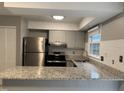 Open kitchen featuring granite countertops, stainless steel appliances, and tile backsplash at 1136 Nottingham Cir, Cary, NC 27511