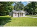 Well-maintained single-story home with neat lawn, side access, and neutral siding with complementary shutters at 125 Brook Pl, Smithfield, NC 27577