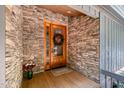 Inviting stone entryway with beautiful wood door and festive wreath at 127 Creekwood, Pittsboro, NC 27312