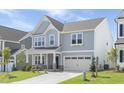Charming two-story home with gray siding, manicured lawn, and attached two car garage at 130 Summer Mist Ln # 160, Clayton, NC 27527