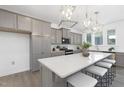 Open kitchen featuring a large island with seating, quartz countertops, and stainless steel appliances at 130 Summer Mist Ln # 160, Clayton, NC 27527