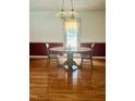 Cozy dining area featuring hardwood floors and a traditional light fixture at 175 Ann Dr, Timberlake, NC 27583