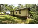Simple home featuring a modest yard in a wooded neighborhood at 181 Mangums Dr, Wendell, NC 27591