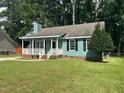Quaint single story home showcasing a well-maintained lawn and traditional architectural style at 2012 Ranch Mill Cir, Raleigh, NC 27610