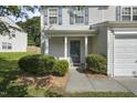 A welcoming front porch features a lovely entrance with neat landscaping and ample natural light at 211 Cloverdale Dr, Durham, NC 27703