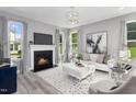 Bright living room with fireplace, stylish furniture, elegant decor, and lots of natural light at 219 Faith Avenue, Sanford, NC 27330
