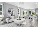 Bright and stylish living room with white sofa, decor, lots of natural light, and open floor plan at 219 Faith Avenue, Sanford, NC 27330