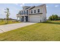 The home is two stories and includes a spacious front yard and two-car garage at 227 Faith Avenue, Sanford, NC 27330