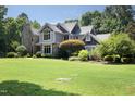 A charming home with stone and siding, a manicured lawn, and lush greenery, creating a welcoming curb appeal at 267 Bald Eagle Dr, Pittsboro, NC 27312