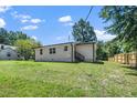 The backyard is large and grassy with a wooden privacy fence at 311 Troy St, Creedmoor, NC 27522