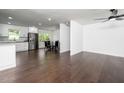 Spacious, open-concept living space with modern finishes, hardwood floors and stainless appliances at 311 Troy St, Creedmoor, NC 27522