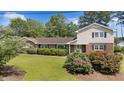 Attractive home features a combination of brick and siding, complemented by verdant landscaping and a well-kept lawn at 315 Crescent Dr, Clayton, NC 27520