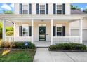 Inviting front porch with white columns, dark shutters, and well-maintained landscaping at 3201 Sawyers Mill Dr, Apex, NC 27539